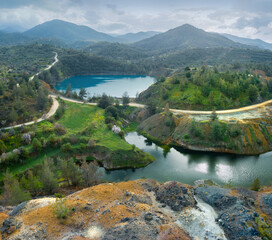 Abandoned Memi mine in Cyprus with colourful pit lake and yellow sulphides tailings