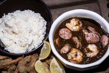 Seafood gumbo with rice and crab fingers.