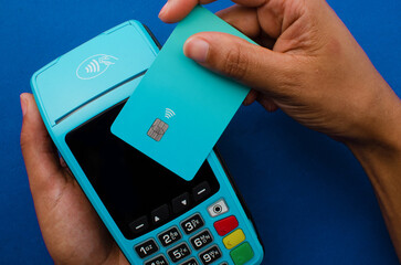 Closeup of hands holding a modern credit card payment device, Contactless technology facilitating fast and secure transactions.