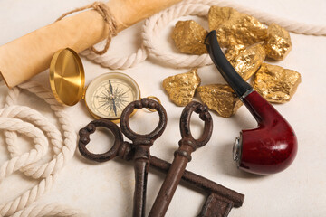 Travel equipment with smoking pipe, keys and golden nuggets on white background