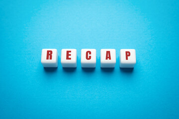 Wooden blocks with the word Recap. A document presenting your skills and achievements. Getting a...