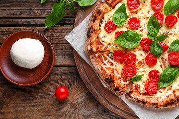 Board with tasty pizza Margarita and Mozzarella cheese on wooden background