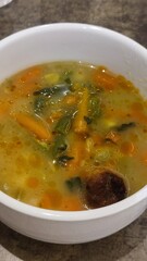 vegetable soup in a round white plate, food, restaurant delicious, lunch dinner serving