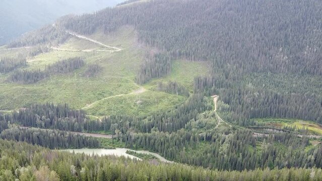 Aerial Forward  Up Forest Lake Valley View. Beautiful landscape in natural sunlight from up above in a slow steady pace.