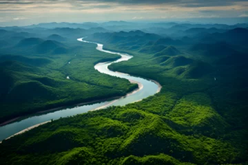 Fototapeten An Aerial Photo of a Pristine River Meandering Through Mountainous Amazon Rainforest © Jack
