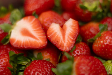 Closeup bowl full of strawberries, strawberry heart, valentines day