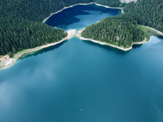 Amazing aerial drone view of Crno Jezero or Black lake, pine forest and cliffs in Durmitor national...