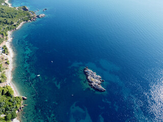 aerial view of small wild rocky island aerial top down view, coral reef around. tourist boats,...