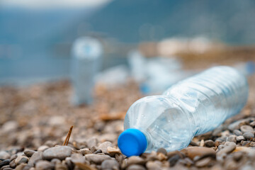 Closeup photo of plastic bottle throw on beach.