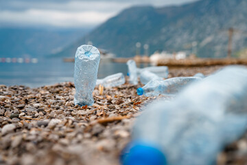 Photo of focused background of thrown plastic bottle on beach.