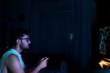 Portrait of a man playing console on television at home