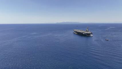 Aerial drone photo of latest technology American flag nuclear aircraft carrier anchored in deep...