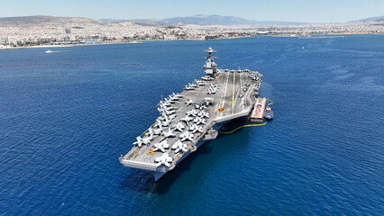 Aerial drone photo of latest technology American flag nuclear aircraft carrier anchored in deep...