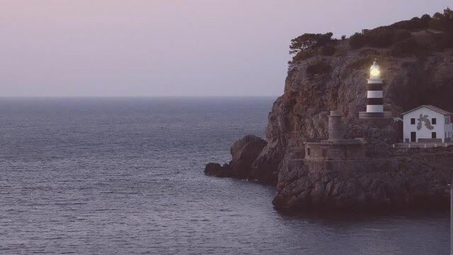 Lighthouse on a rock by the sea. Port Soller. Majorca. Spain