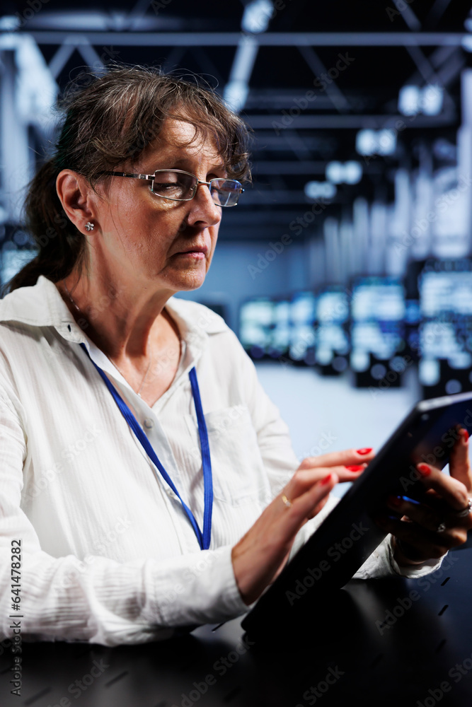 Poster octogenarian admin using tablet to assess server cybersecurity flaws arising due to unsecured networ