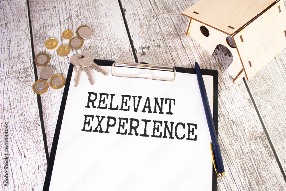 Poster relevant experience text on paper with keyboard, calculator on grey background.