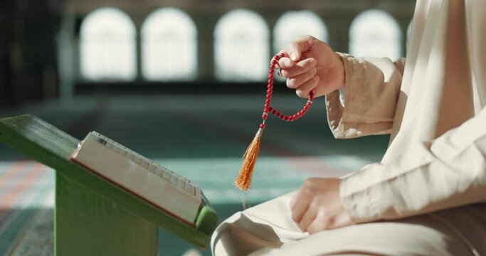 Islam, prayer beads and man in mosque with Quran, mindfulness and gratitude in faith. Worship, religion and Muslim scholar in holy temple for praise with book, spiritual teaching and peace meditation