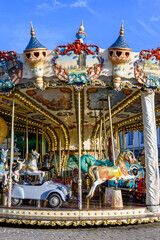 Colorful traditional old french caroussel in city park in sunny day