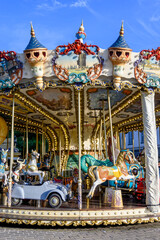 Fototapeta premium Colorful traditional old french caroussel in city park in sunny day