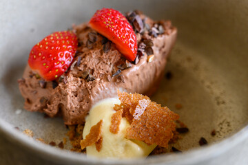 Exquisite dessert with ice cream of modern French haute cuisine prepared with fresh organic ingredients from restaurant’s own garden and farm and beautifully served