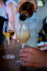 Tasting of sparkling white wine with bubbles champagne on summer festival route of champagne in Cote des Bar, Champagne region, France