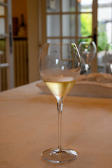 Tasting of grand cru sparkling white wine with bubbles champagne in old champagne house in grand cru wine producer small village Ambonnay, Champagne, France