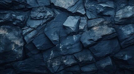 Close-up of dark blue rock texture with cracks, rough rock surface, granite and stone background for design, nature