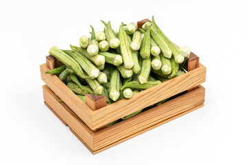 Fresh okra on the wooden container.