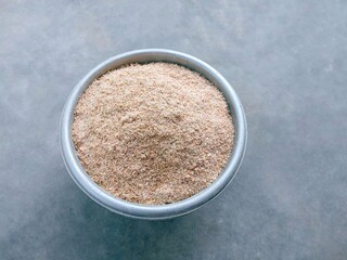 Paddy bran. Smooth rice husk on gray background. Bekatul. Dedak. Rice bran. Top view