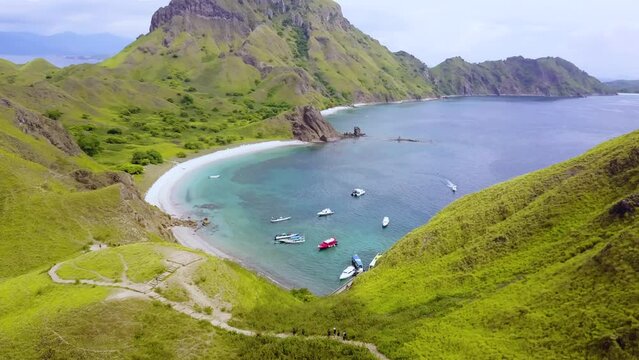 Aerial View Padar Island, Labuan Bajo, Indonesia. Capturing ocean and beautiful landscape of sky, hills and coastal beach.