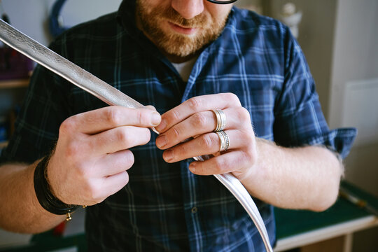 Craftsman making leather bag