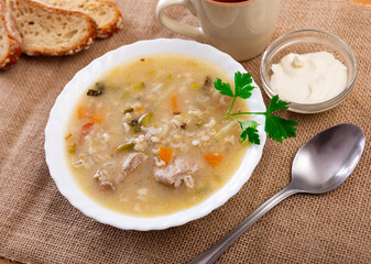 Popular dish of Russian cuisine is pickle soup with meat, cooked on basis of pickled cucumbers and...