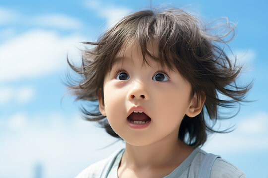 Portrait of a little Japanese kid playing in kindergarten. Closeup of little boy outdoors radiating the joy of play in a moving image of innocence and exuberance.