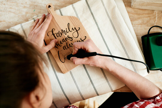 Female pyrographer working in studio