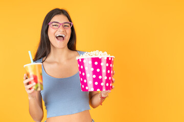 Happy woman with a soda and a pop corn bag