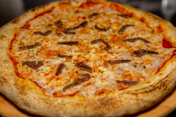 Traditional anchovy pizza (alicci) with artisan long-matured dough. 