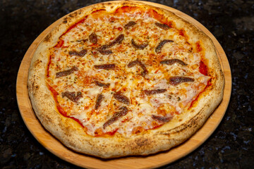 Traditional anchovy pizza (alicci) with artisan long-matured dough. 