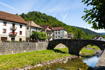 Fototapeta na wymiar Picturesque village of Ochagavia with beautiful houses, stone bridge and natural environment near the Pyrenees in Spain