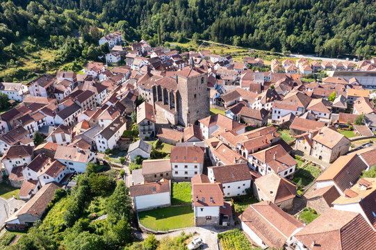 Dense urban development of medieval Spanish town of Isaba, view from above. Wide view of settlement and adjacent forests and mountains, view from observation deck, from quadrocopter drone