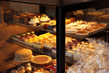 Counter with different tasty desserts in bakery shop
