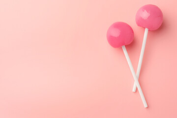Tasty lollipops on pink background, flat lay. Space for text