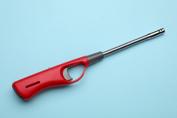 One gas lighter on light blue background