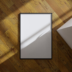 aesthetic frame mockup poster laying on the wooden floor lit by sunlight