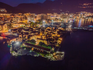 Budva city lights from Montenegro seen from above. Night view. Drone old town Budva at night