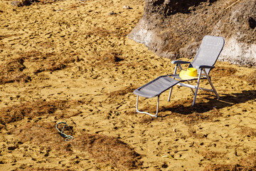 Fototapeta na wymiar Deckchair on sandy beach
