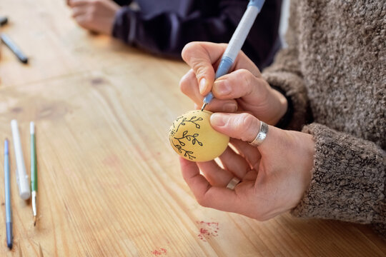 Woman decorating Easter egg