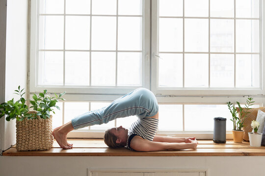 Woman practising Halasana