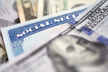 Social security card with US currency. Retirement benefit concept