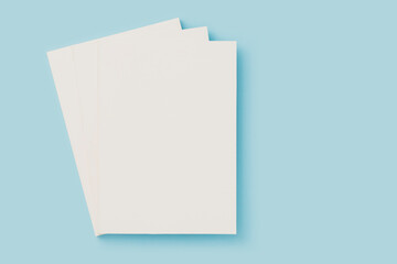 White blank cover magazine stack, mockup on blue background