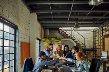 Young and diverse group of coworkers working on a project and having a meeting in a startup company office